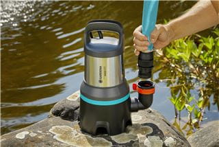 A person connecting a hose with a GARDENA submersible pump