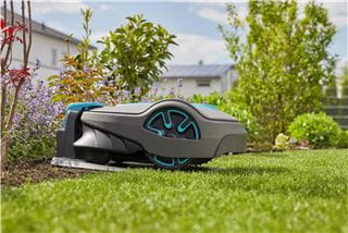 Close-up on a Gardena robotic lawnmower in its docking station