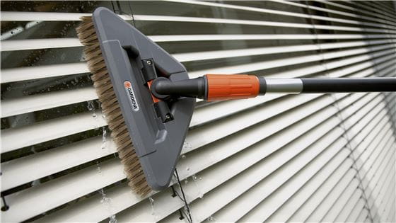 Gardena Wash Brush cleaning the blinds of a window