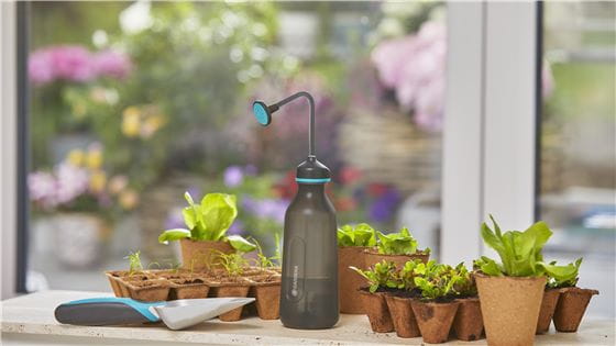 A Gardena Soft Sprayer with some seedlings on a windowsill